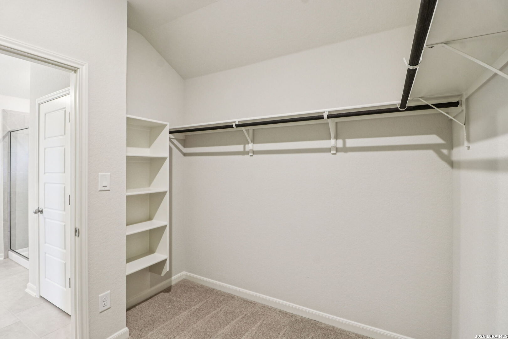 9909 Paladin Ridge San Antonio, TX 78254 - Photo 25 of 41 a view of walk in closet with empty racks