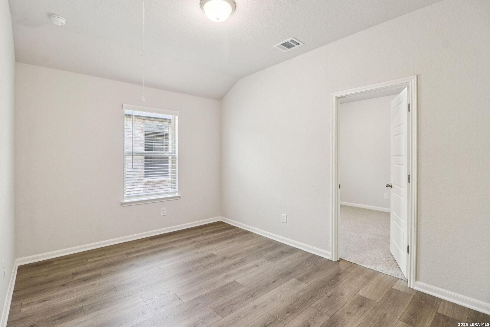 9909 Paladin Ridge San Antonio, TX 78254 - Photo 28 of 41 an empty room with wooden floor and windows