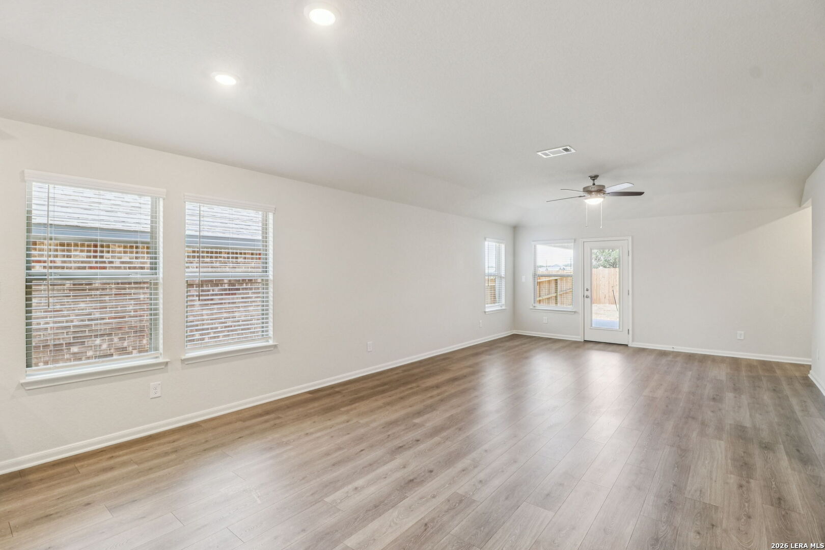 9909 Paladin Ridge San Antonio, TX 78254 - Photo 5 of 41 wooden floor in an empty room with a window