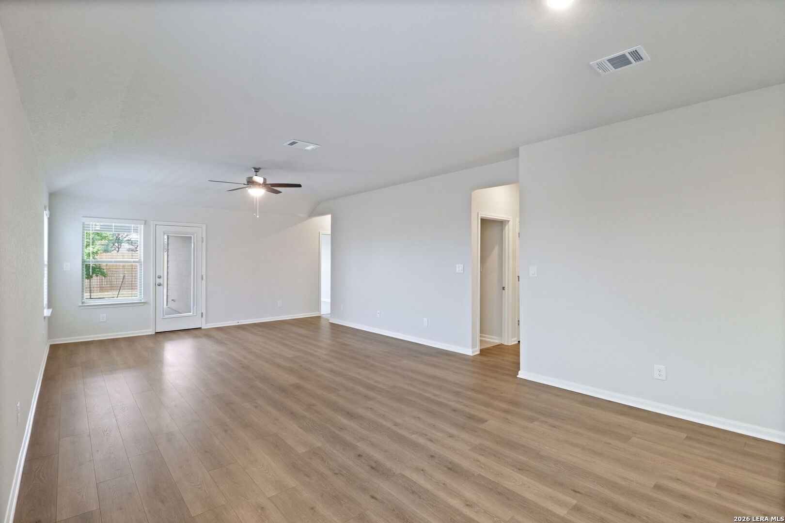 9909 Paladin Ridge San Antonio, TX 78254 - Photo 7 of 41 an empty room with wooden floor and windows