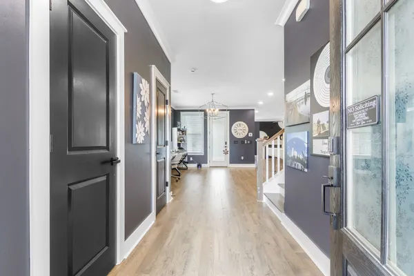 a view of a hallway view with large mirror and furniture