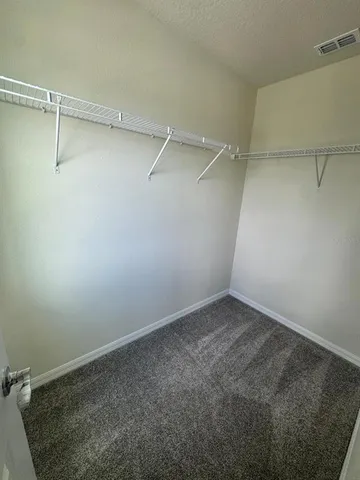 a bathroom with a double vanity sink a toilet and a mirror