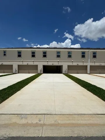 a kitchen with kitchen island a white counter top space cabinets and stainless steel appliances