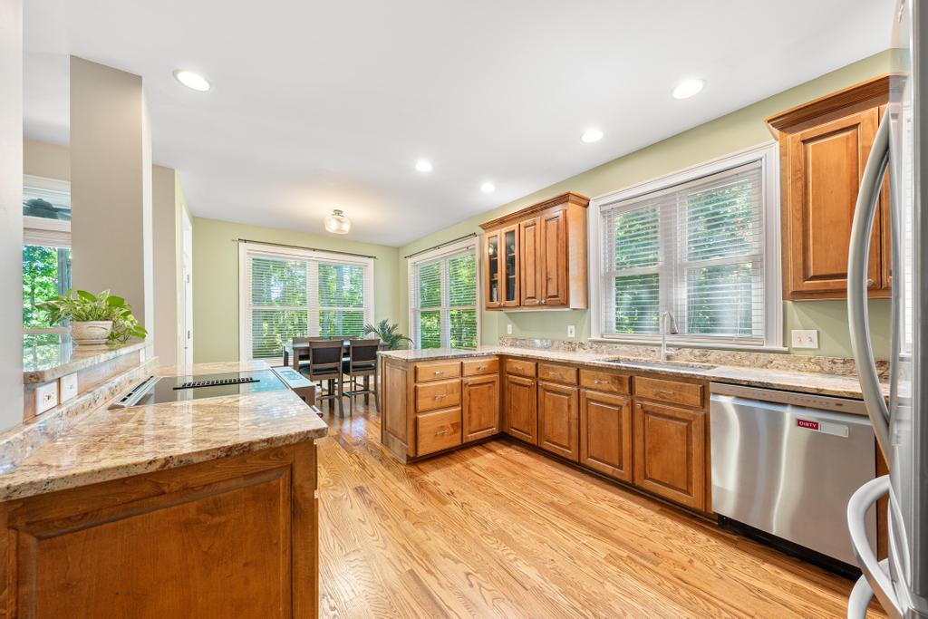 217 Maret Road Townville, SC 29689 - Photo 5 of 35 A generous kitchen boasts rich cabinetry and ample counter space, flowing into a dining area.