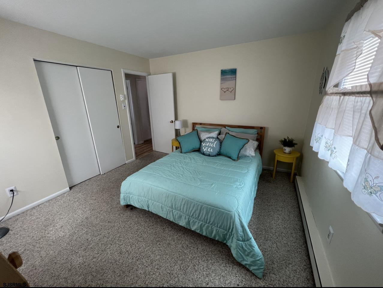 215 2nd Street North, Unit 1 Brigantine, NJ 08203 - Photo 13 of 24 a bedroom with a bed and a window