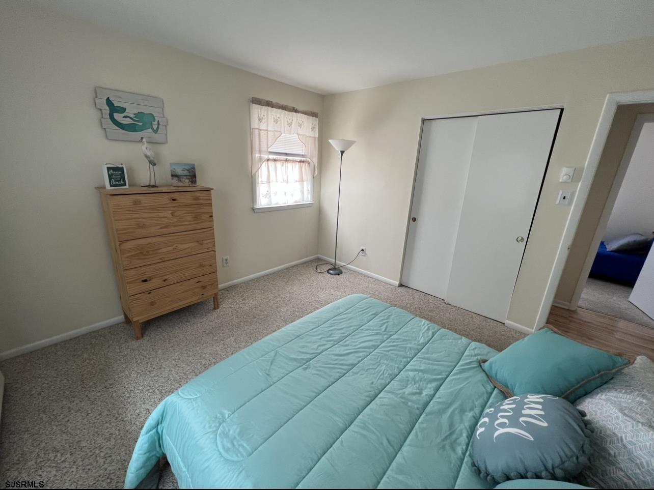 215 2nd Street North, Unit 1 Brigantine, NJ 08203 - Photo 14 of 24 a bedroom with a bed and a window