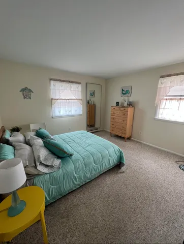 a bedroom with bed and window