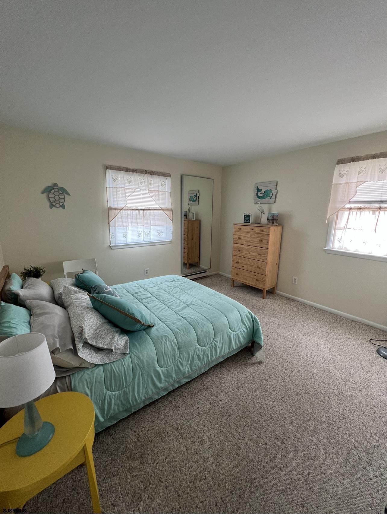 215 2nd Street North, Unit 1 Brigantine, NJ 08203 - Photo 15 of 24 a bedroom with bed and window
