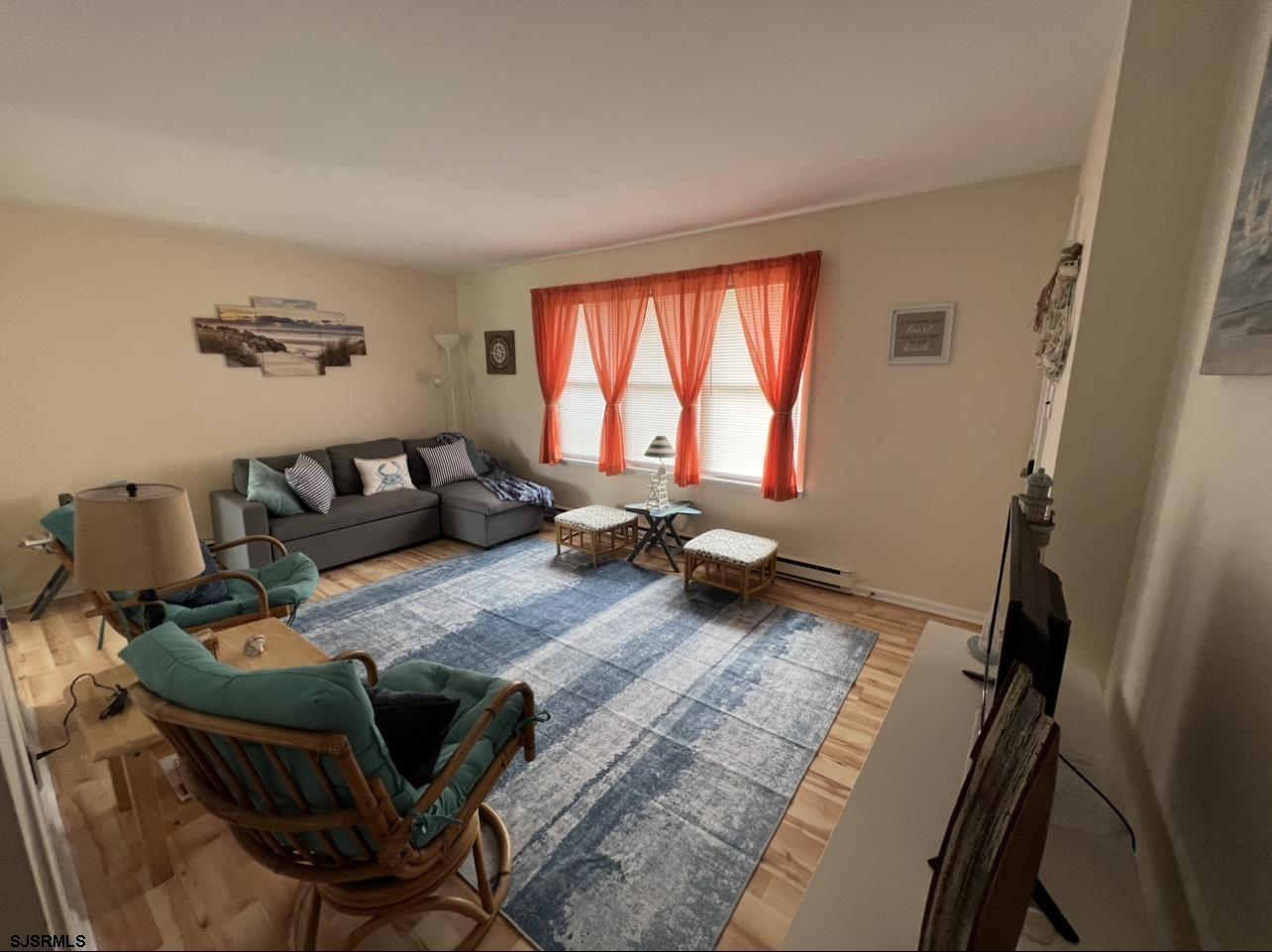 215 2nd Street North, Unit 1 Brigantine, NJ 08203 - Photo 6 of 24 a living room with furniture and a window