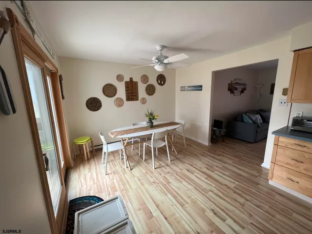 a dining room with furniture and wooden floor