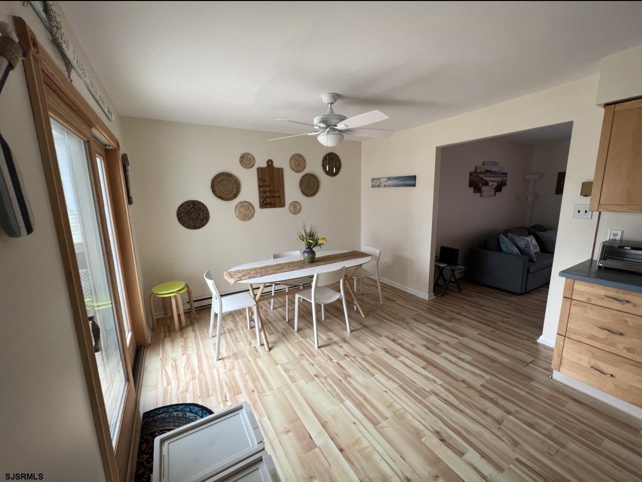 215 2nd Street North, Unit 1 Brigantine, NJ 08203 - Photo 9 of 24 a dining room with furniture and wooden floor