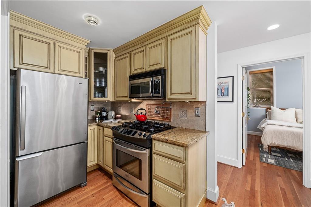 1116 Piedmont Avenue Northeast, Unit 10 Atlanta, GA 30309 - Photo 18 of 59 a kitchen with stainless steel appliances a refrigerator stove and microwave