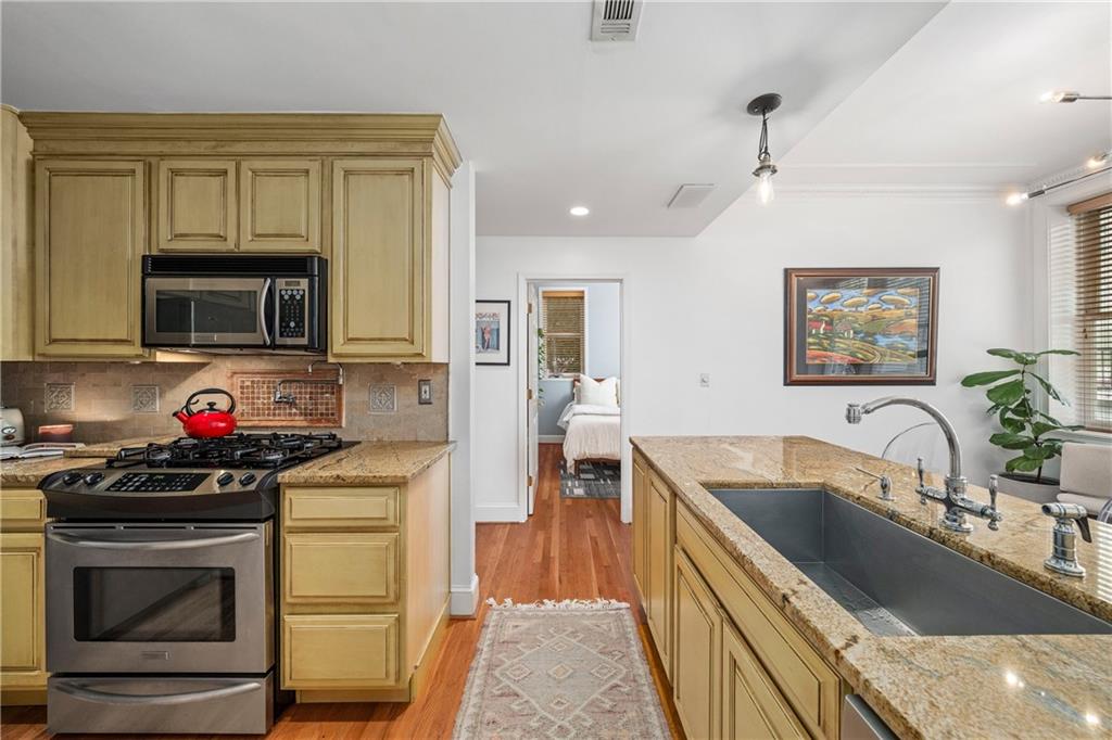 1116 Piedmont Avenue Northeast, Unit 10 Atlanta, GA 30309 - Photo 19 of 59 a kitchen that has a sink and a stove top oven