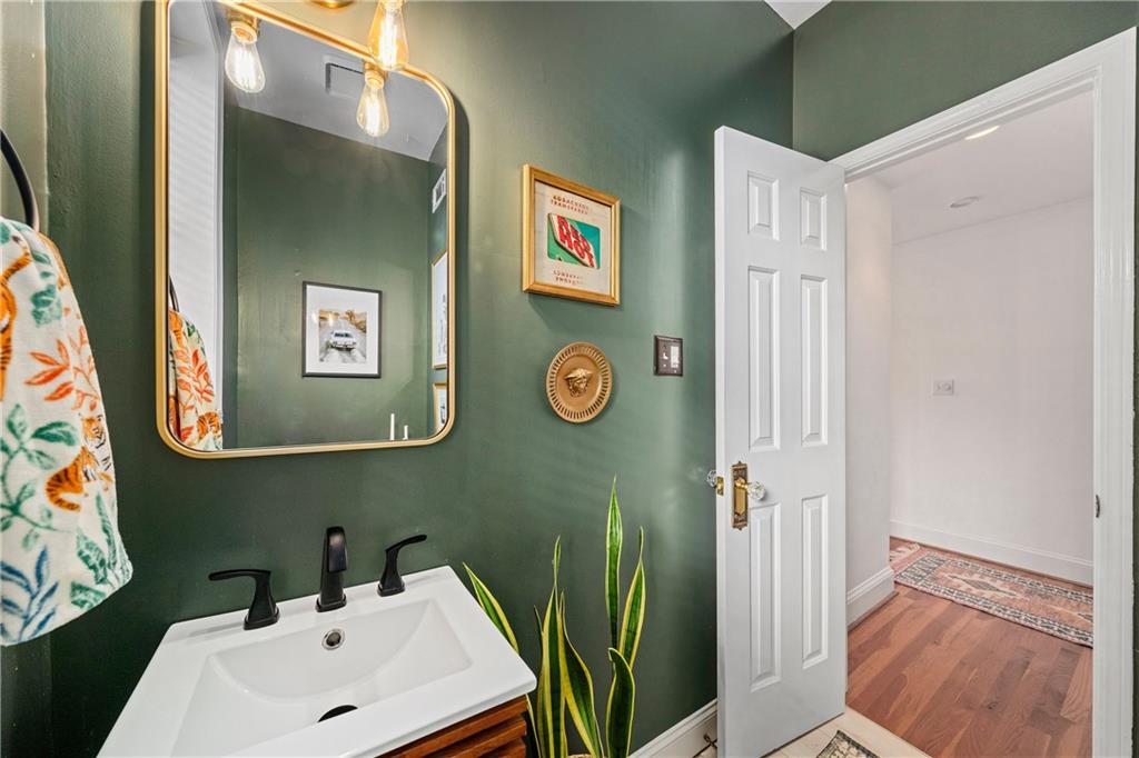 1116 Piedmont Avenue Northeast, Unit 10 Atlanta, GA 30309 - Photo 24 of 59 a bathroom with a sink a mirror and a toilet