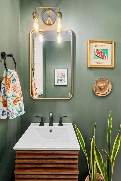 1116 Piedmont Avenue Northeast, Unit 10 Atlanta, GA 30309 - Photo 25 of 59 a bathroom with a sink a mirror and painting on the wall