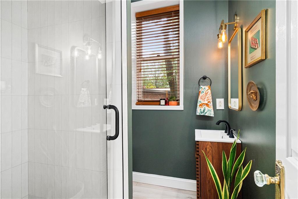 1116 Piedmont Avenue Northeast, Unit 10 Atlanta, GA 30309 - Photo 26 of 59 a bathroom with a shower and a mirror