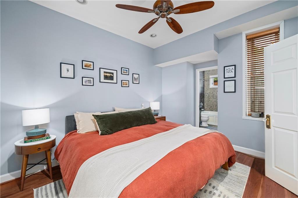 1116 Piedmont Avenue Northeast, Unit 10 Atlanta, GA 30309 - Photo 30 of 59 a bedroom with a bed and wooden floor