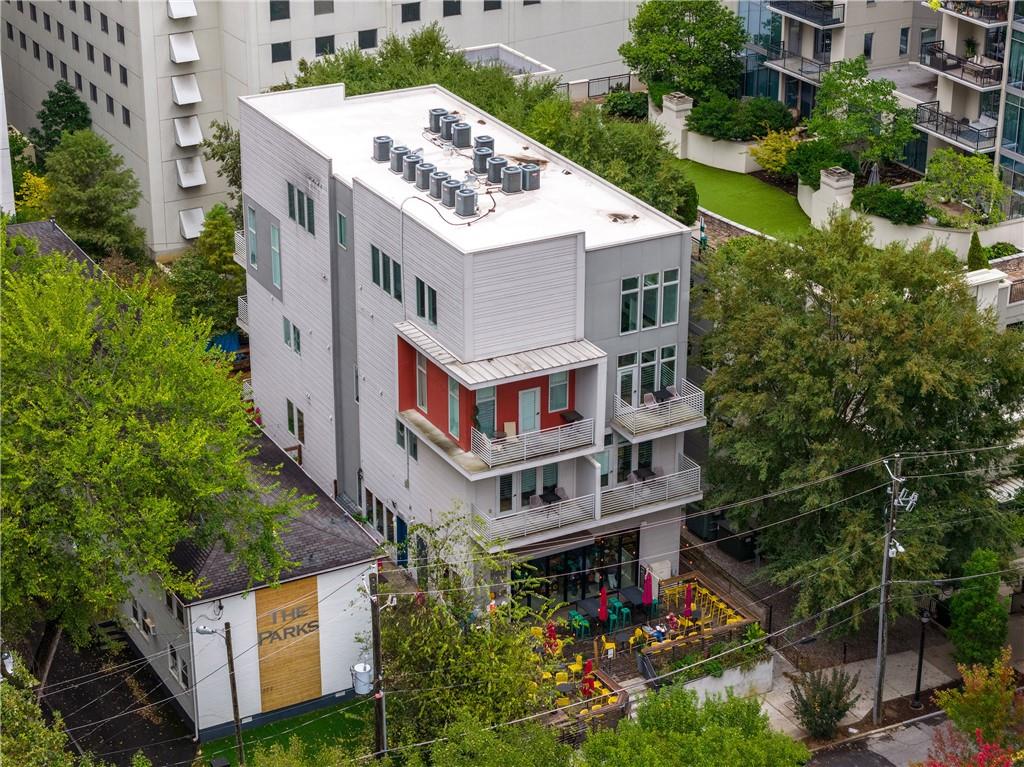 1116 Piedmont Avenue Northeast, Unit 10 Atlanta, GA 30309 - Photo 57 of 59 an aerial view of a house with balcony and trees