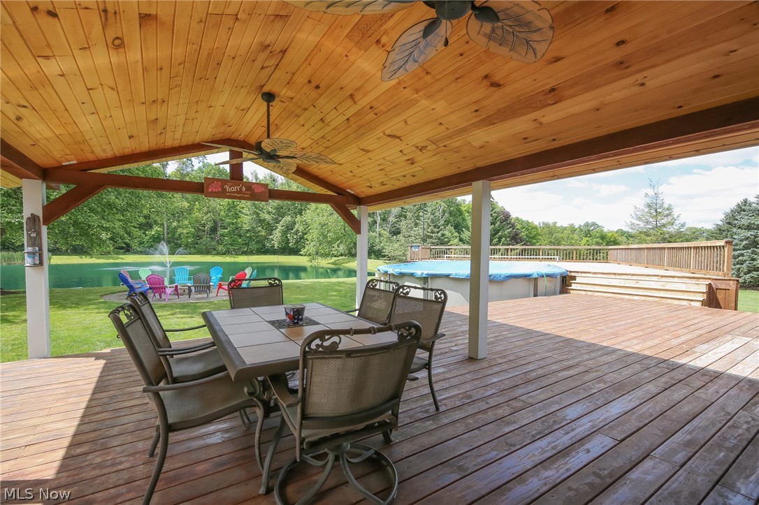 3362 Granger Road Medina, OH 44256 - Photo 36 of 49 Wooden terrace featuring a covered pool, ceiling fan, and a lawn