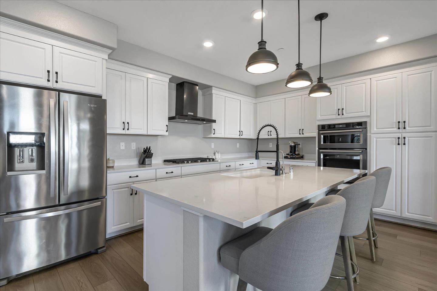 6823 Vector Court San Jose, CA 95119 - Photo 12 of 51 a kitchen with refrigerator a stove a sink and a refrigerator with wooden floor