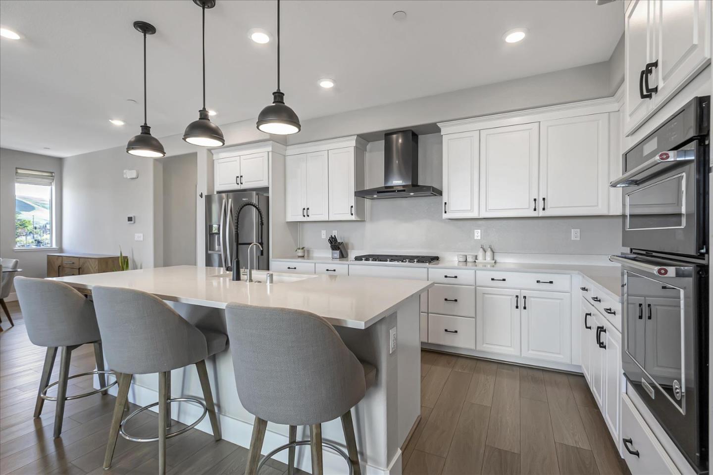 6823 Vector Court San Jose, CA 95119 - Photo 16 of 51 a kitchen with white cabinets and stainless steel appliances