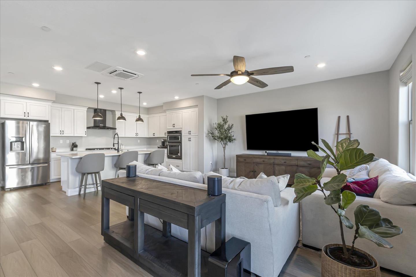 6823 Vector Court San Jose, CA 95119 - Photo 8 of 51 a living room with kitchen island furniture and a flat screen tv