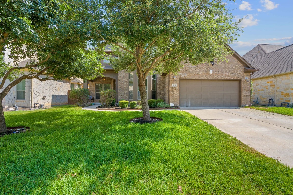 a front view of house with yard and green space