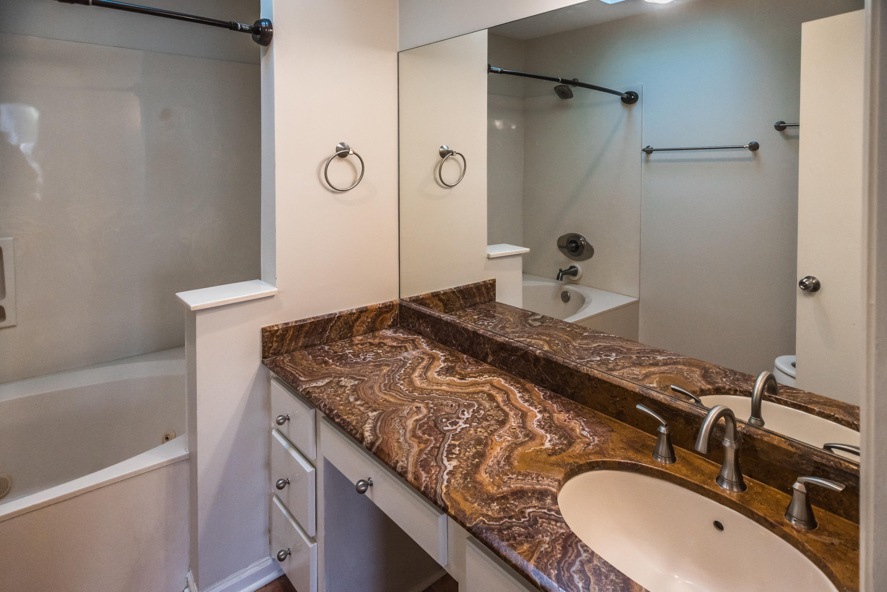 52 Rue D Honfleur Destin, FL 32541 - Photo 11 of 22 a bathroom with a granite countertop sink a mirror and shower