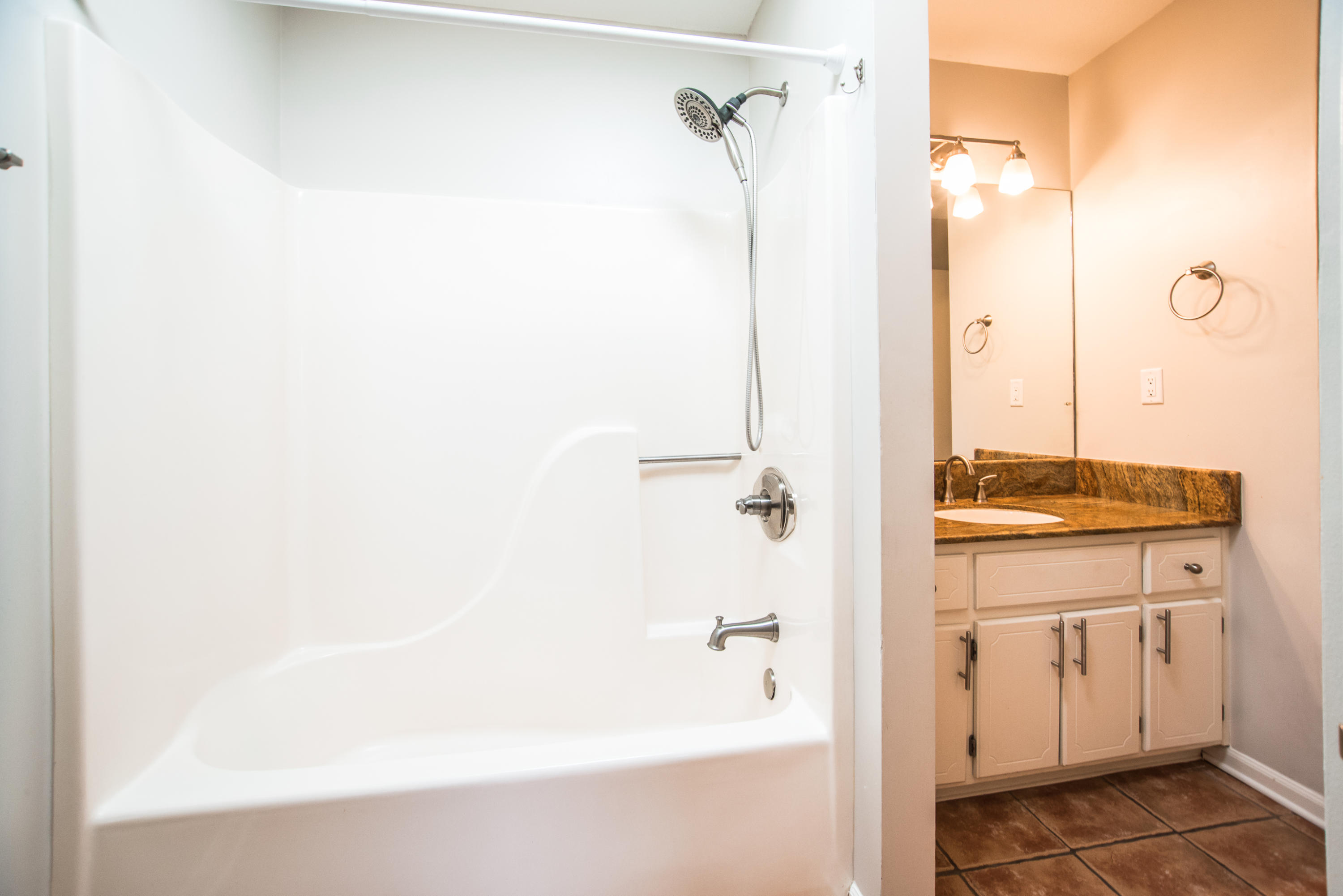52 Rue D Honfleur Destin, FL 32541 - Photo 19 of 22 a bathroom with a granite countertop sink a mirror and a bathtub