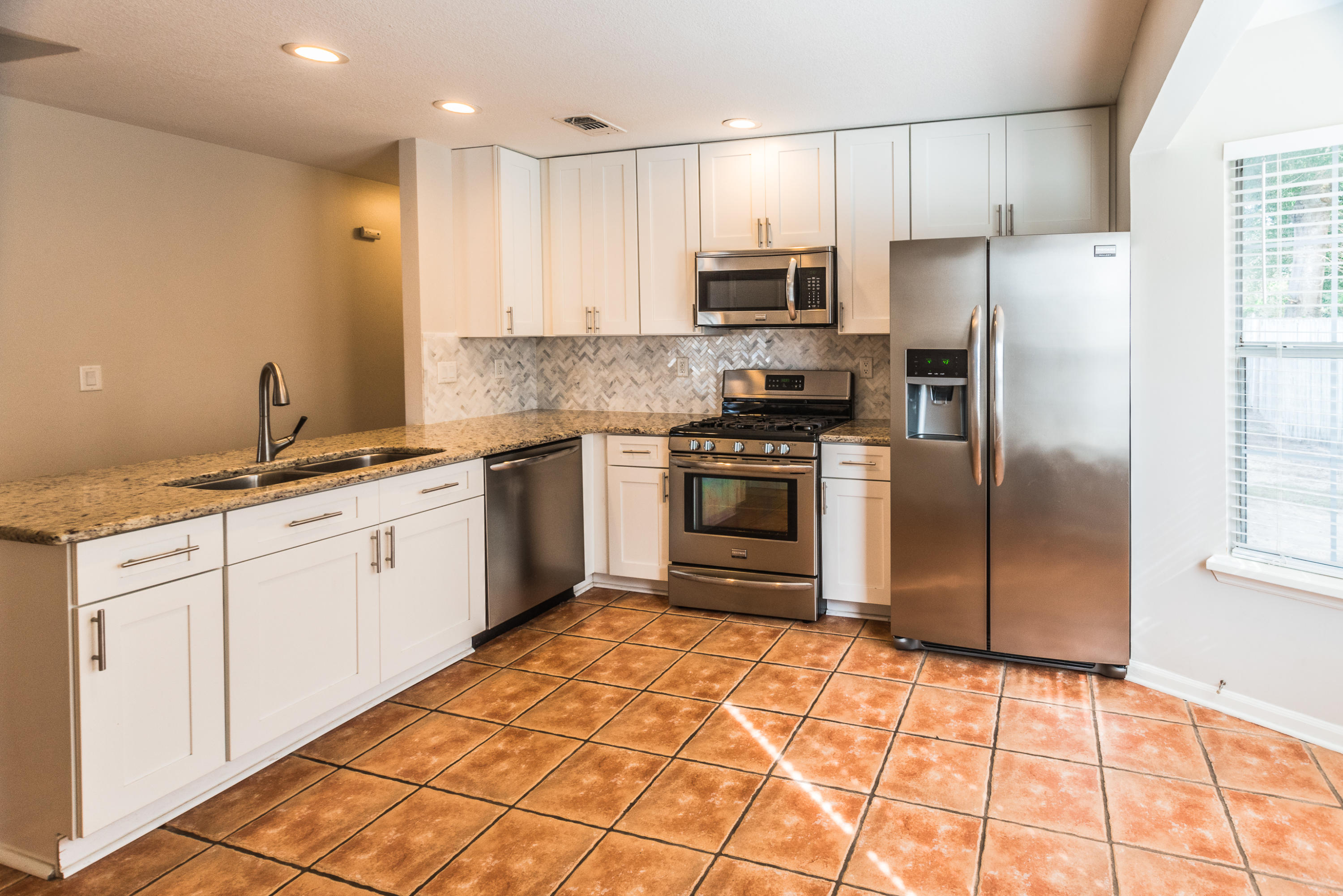52 Rue D Honfleur Destin, FL 32541 - Photo 5 of 22 a kitchen with stainless steel appliances granite countertop a refrigerator sink and white cabinets