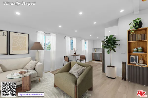 a living room with furniture potted plant and a table