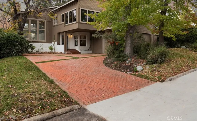a front view of a house with garden