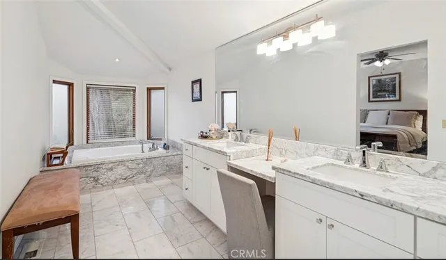 a bathroom with a granite countertop sink a mirror and vanity