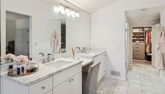 a bathroom with a double vanity sink and a mirror