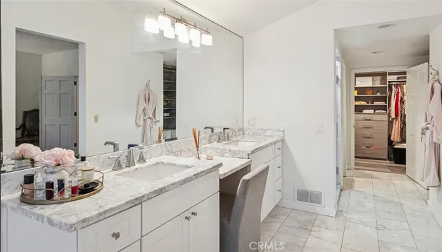a bathroom with a double vanity sink and a mirror