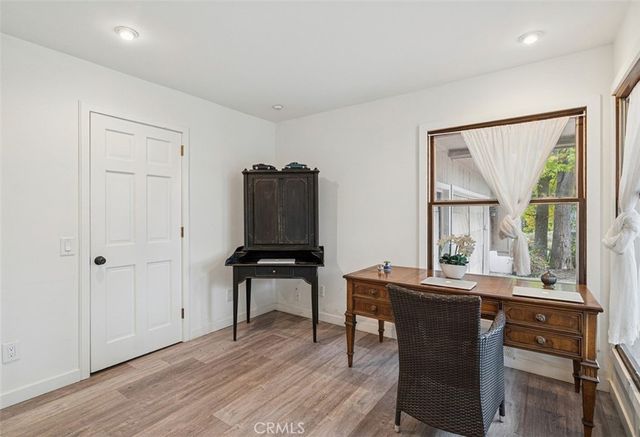 a view of a workspace with furniture and a window