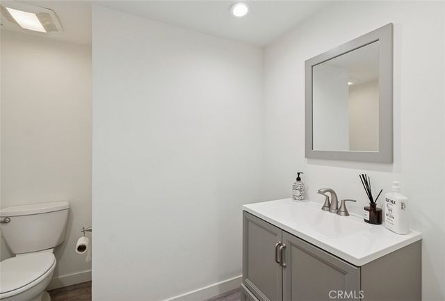 a bathroom with a sink toilet and mirror