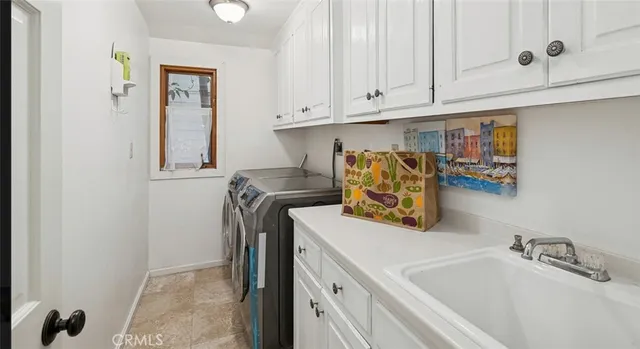 a bathroom with a sink and mirror with bathtub