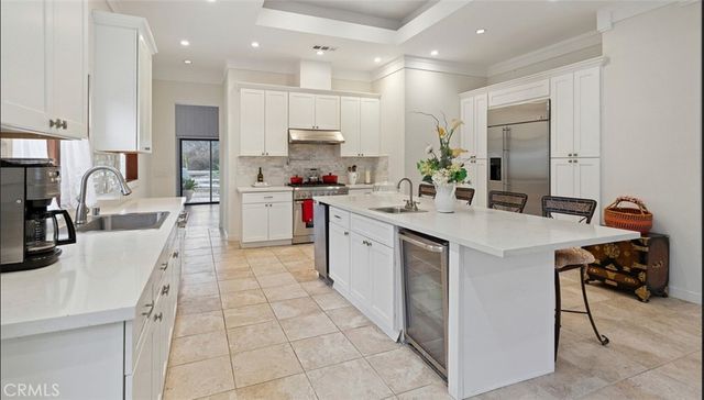 a kitchen with stainless steel appliances kitchen island granite countertop a sink and cabinets