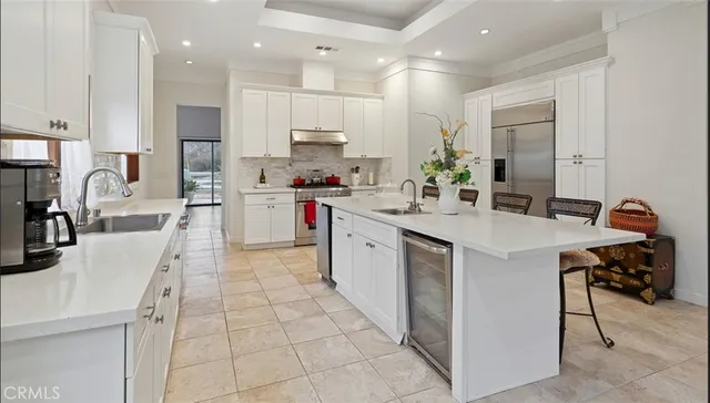 a kitchen with stainless steel appliances kitchen island granite countertop a sink and cabinets