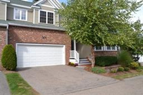 3 Indian Woods Way, Unit 3 Canton, MA 02021 - Photo 2 of 10 a front view of a house with a yard and garage