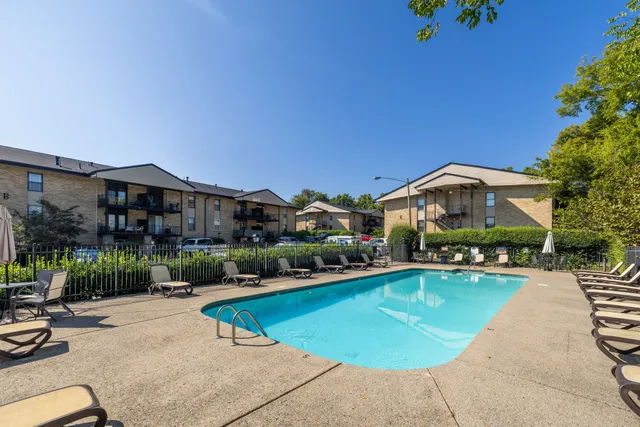 an outdoor space with swimming pool and furniture
