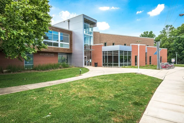 a patio with a table and chairs under an umbrella
