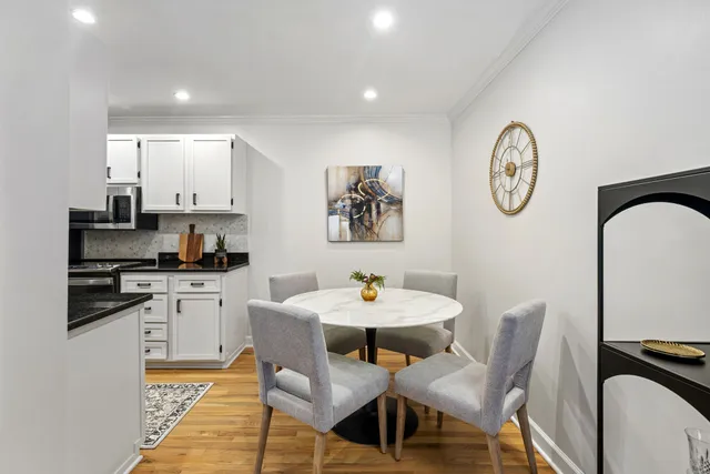 a view of a dining room with furniture and wooden floor