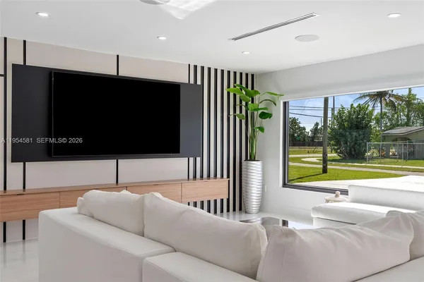 a kitchen with a table chairs sink and cabinets