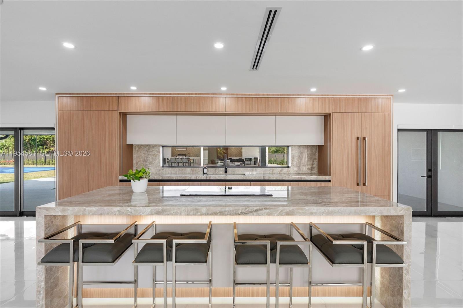 12425 Southwest 226th Street Miami, FL 33170 - Photo 15 of 75 a kitchen with a table chairs sink and cabinets