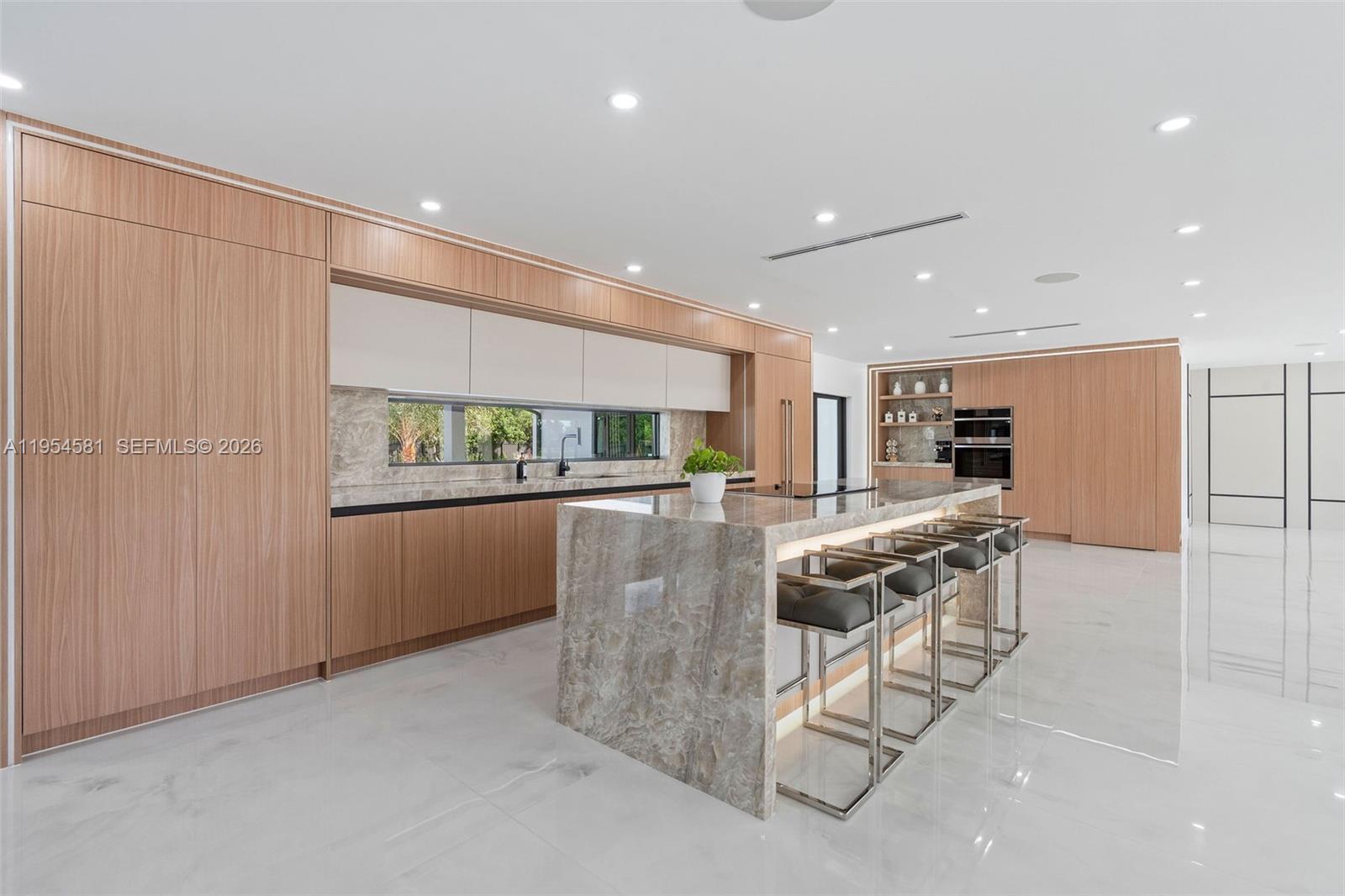 12425 Southwest 226th Street Miami, FL 33170 - Photo 16 of 75 a kitchen with stainless steel appliances kitchen island granite countertop a refrigerator and a stove top oven