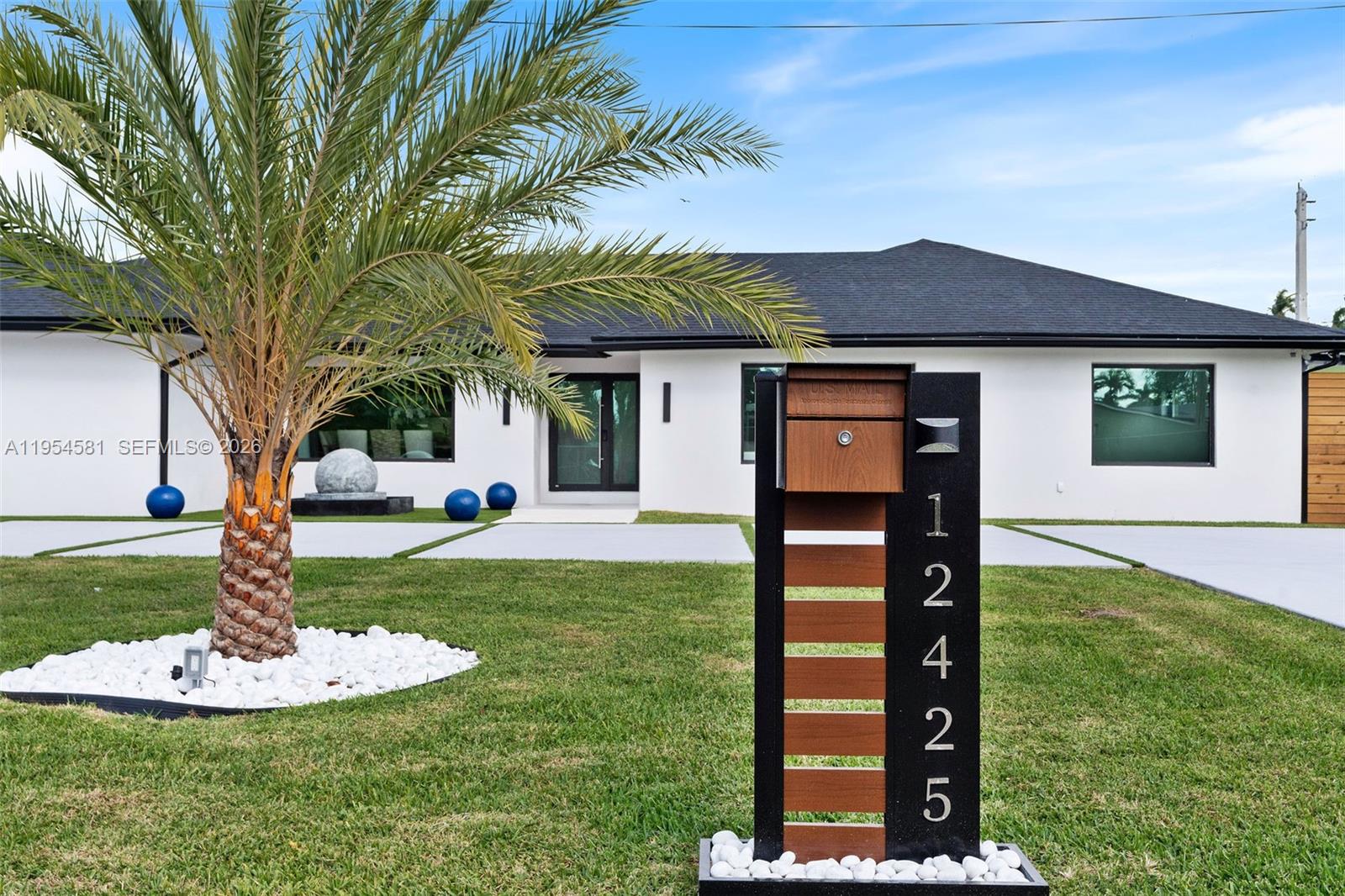 12425 Southwest 226th Street Miami, FL 33170 - Photo 2 of 75 a front view of a house with a yard