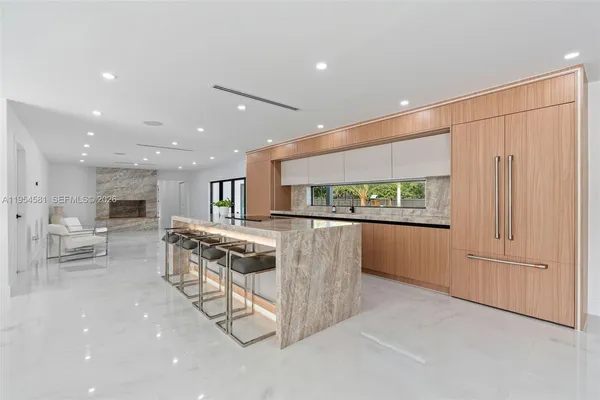 a view of a livingroom with furniture and a flat screen tv