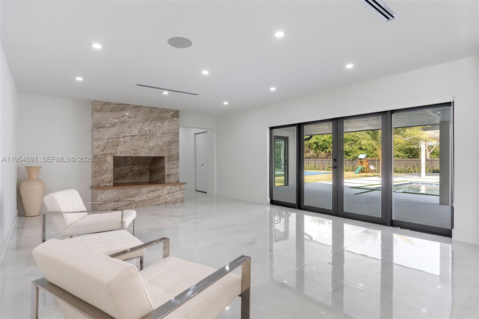 12425 Southwest 226th Street Miami, FL 33170 - Photo 26 of 75 a living room with furniture and a fireplace